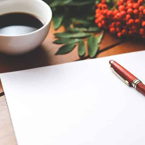 Pen and paper with coffee