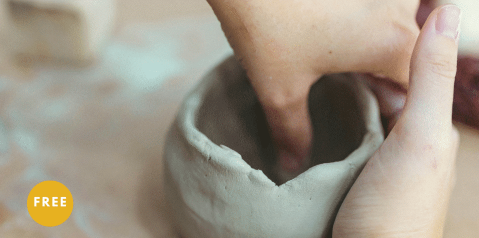 hands forming clay pot
